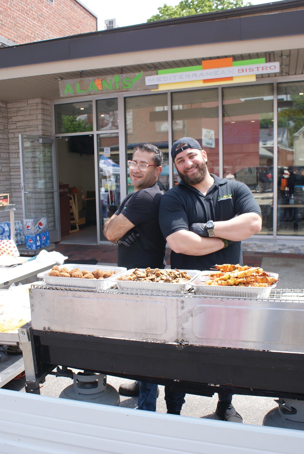BLAST FROM THE MEDITERANIAN: Alanis mediterranean Bistro served up gyros, falafel, chicken tenders and tender steak to those stopping by during the festival. Head chef Sami Almuhtaseb (left) and Part-Owner Mohammad Alani proudly smiled and dished out delicious flavors.